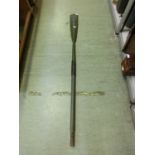 An ornamental green oar numbered '61' approximately 6ft long