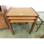 A nest of three mid-20th century teak tables