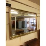 An ornate gilt framed bevel glass mirror