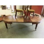 A late 19th century walnut extending dining table with wind-out mechanism and turned fluted legs,