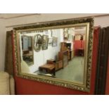 A floral gilt framed bevel glass mirror