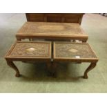 An Indian carved walnut coffee table along with a pair of matching occasional tables