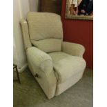 A modern beige upholstered reclining armchair