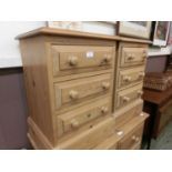 A pair of waxed pine bedside chests of three drawers