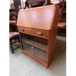 A mid-20th century fall front bureau having drawer above fall with glazed sliding doors to base