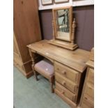 A waxed pine dressing table with three drawers together with a matching swing mirror and stool