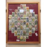 A collection of mounted Wills cigarette cards