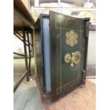 A late 19th century metal safe having a brass plaque to front 'George Titterton Maker Birmingham'