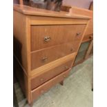 A mid-20th century veneered chest of four drawers having mirror to back