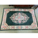 A Chinese green ground rug