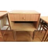 A mid-20th century teak bedside table, single drawer over open storage