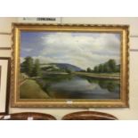 A gilt framed oil on canvas of cattle looking over river signed bottom left