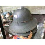 Two mid-20th century steel military helmets