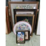 A collection of framed and unframed artworks, mainly needleworks