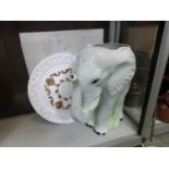 A white ceramic vessel in the form of elephant together with a white and gilt painted plaster