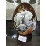 A hand painted blown ostrich egg with African animal design