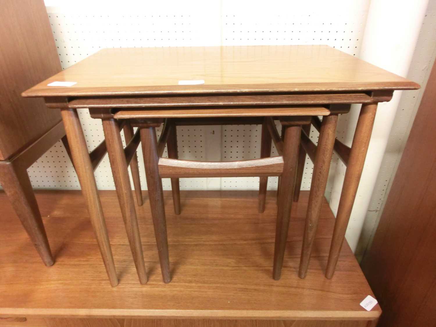 A nest of three mid-20th century teak tables