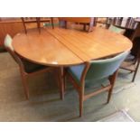 A mid-20th century teak extending dining table along with a set of four matching chairs