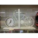 A reproduction vintage style pair of metalwork book ends in the form of bicycle and clock