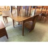 An oak drop leaf table with storage to base