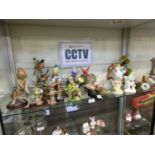 A shelf of ceramic and moulded figures of birds by various makers