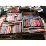 Four trays of books to include hunting, veterinary books, novels, etc