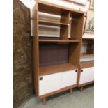 A 1980s laminated teak effect unit having open storage with the base having a pair of sliding doors