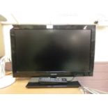 A Toshiba flat screen television with remote