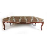 A 19th century French walnut stool of trapezium form upholstered in a floral patterned fabric the