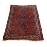 A handwoven Caucasian rug, the multi line border surrounding a red ground field with animal and