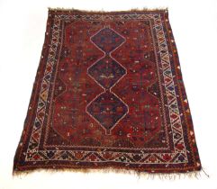 A handwoven Caucasian rug, the multi line border surrounding a red ground field with animal and