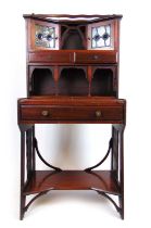 An Arts and Crafts mahogany desk, the superstructure with leaded light cupboard doors and drawers