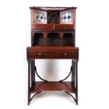 An Arts and Crafts mahogany desk, the superstructure with leaded light cupboard doors and drawers