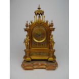 A late 19th century French brass and polychrome mantle clock, the face with Roman numerals flanked