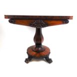 A William IV rosewood card table, the fold over top supported on a swivel action above the faceted