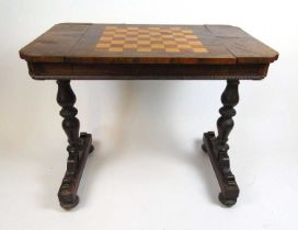 A Victorian rosewood and inlaid games table, the top with satinwood and mahogany chess board sliding