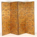 A 19th century embossed and polychrome leather four fold screen with gold ground floral and urn