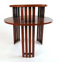 An early 20th century walnut two tier occasional table, the circular top and undertier supported