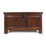 A late 17th/early 18th century oak coffer, the top lifting to reveal a vacant interior over the