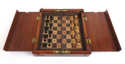 An early 20th century folding travelling chess set with carved boxwood pieces, Board 15.5 cm x 15.