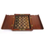 An early 20th century folding travelling chess set with carved boxwood pieces, Board 15.5 cm x 15.