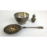 A Victorian silver sugar bowl and pepper pot together with a white metal tea strainer. Various