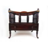 A Regency mahogany canterbury, the divisions with turned supports over the single drawer on turned