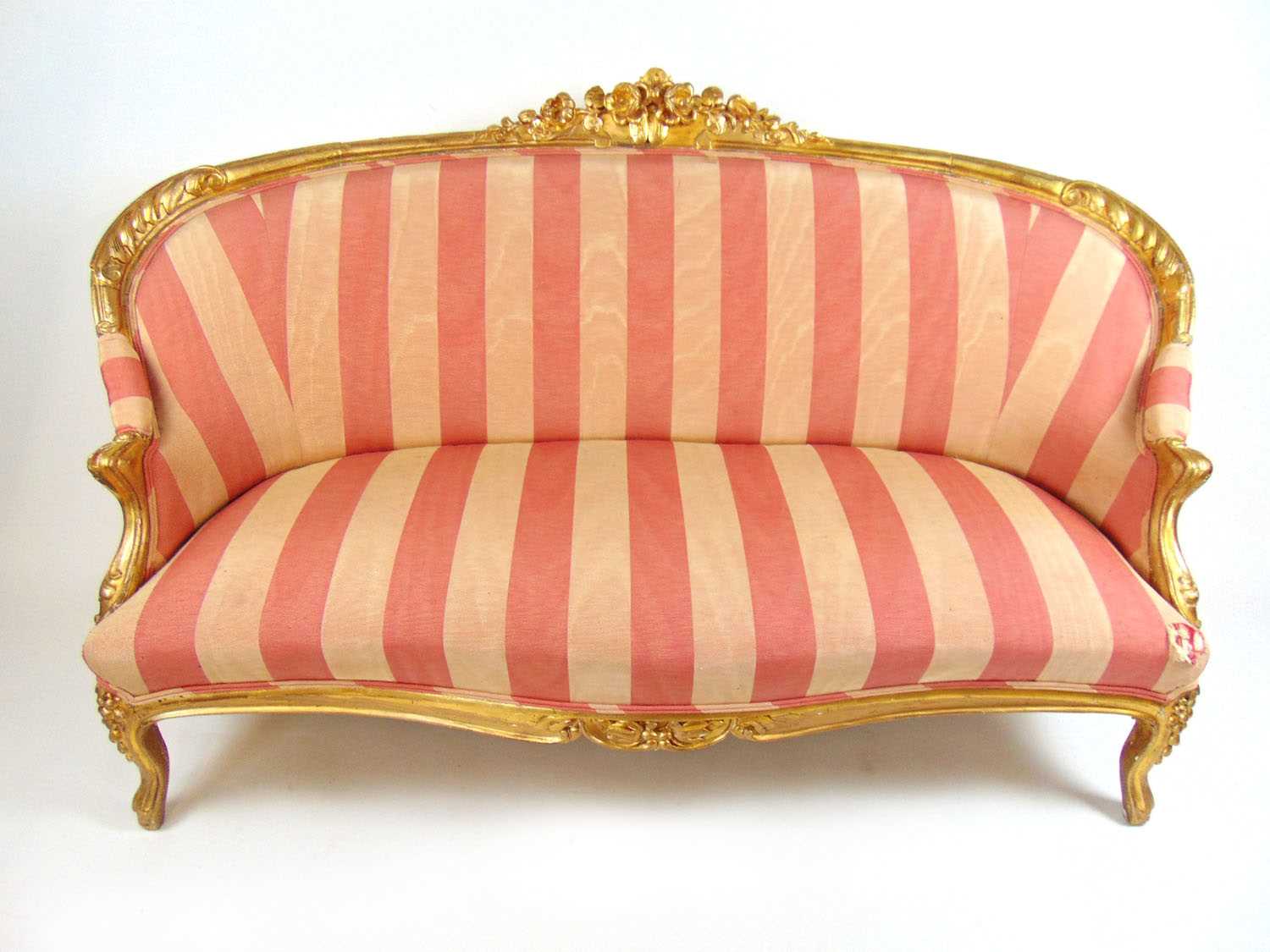 A 19th century carved giltwood settee upholstered in a striped pink fabric, the floral top rail - Image 2 of 2