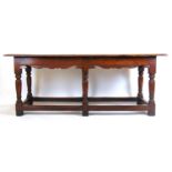 A late 17th century style oak refectory table, the moulded two piece top on six turned legs united