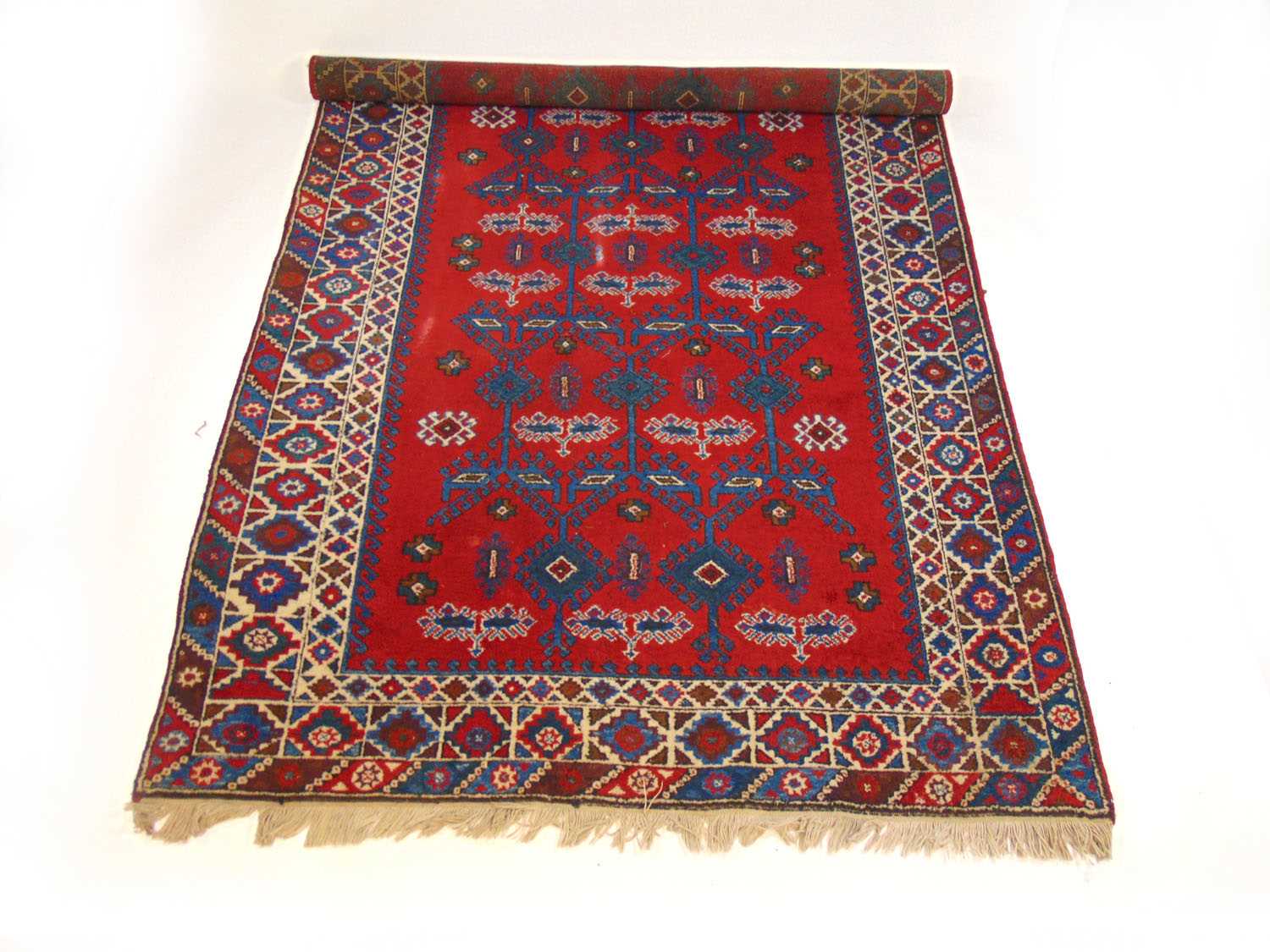 A handwoven Turkish rug, the triple line border surrounding the red ground field with serrated - Image 2 of 2