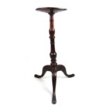 An 18th century and later oak candle stand, the dish top over a turned column and three legs, h.