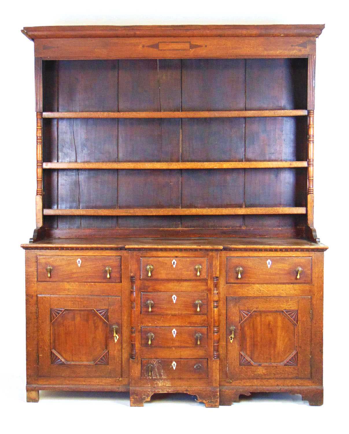 An 18th oak, mahogany and inlaid dresser, the plate rack with fixed shelves flanked by split