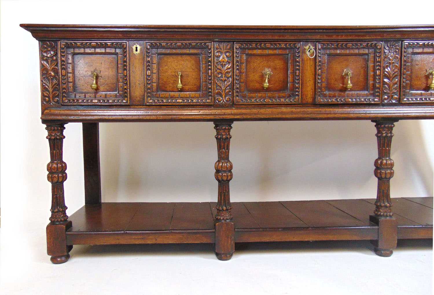 A 17th century style oak dresser base, the top over three panel front drawers over carved legs and - Image 2 of 12