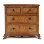 An early 20th century Cotswold school limed oak miniature chest, the top lifting with two dummy